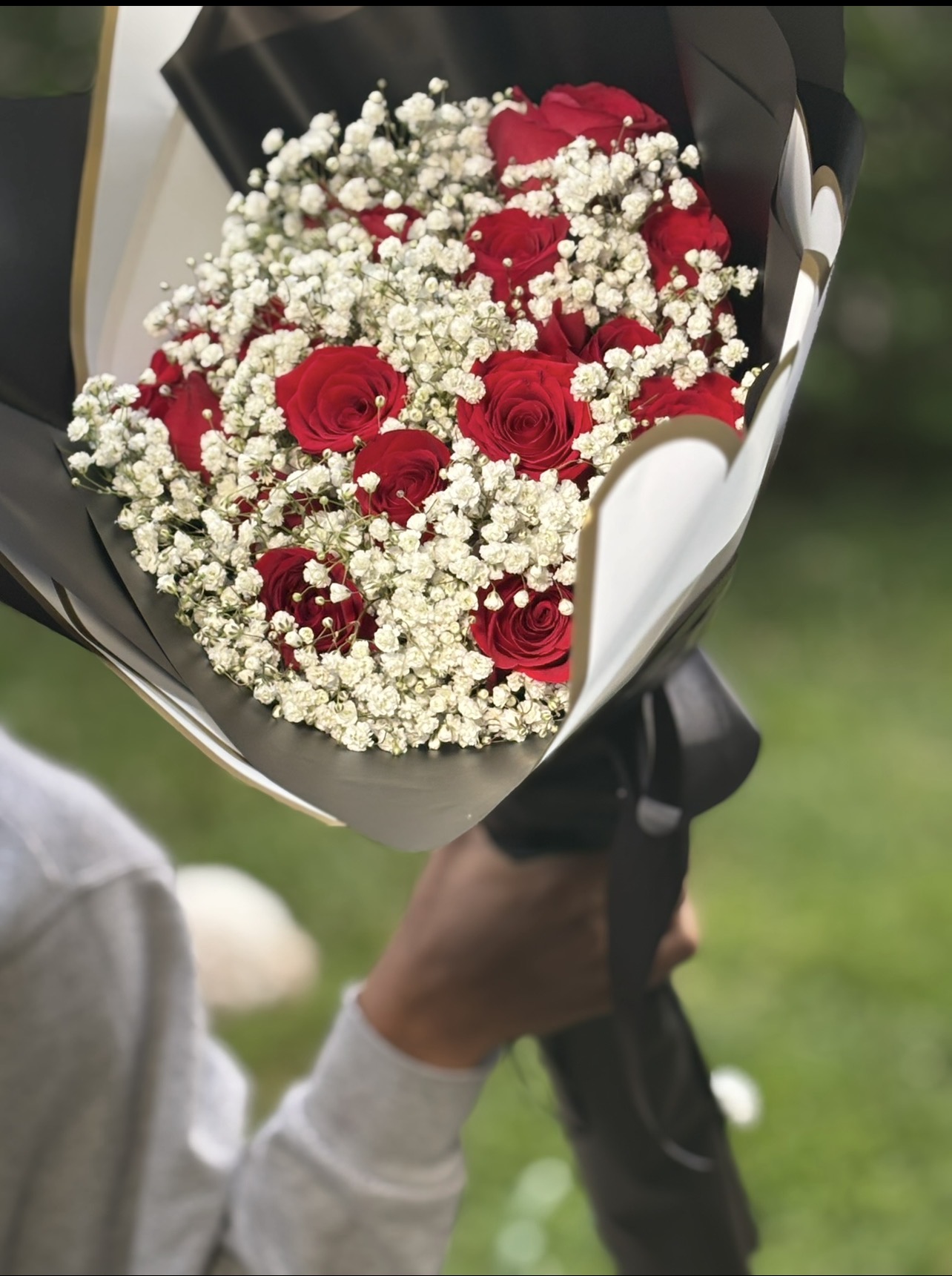Luxury red rose bouquet with baby's breath wrapped in black